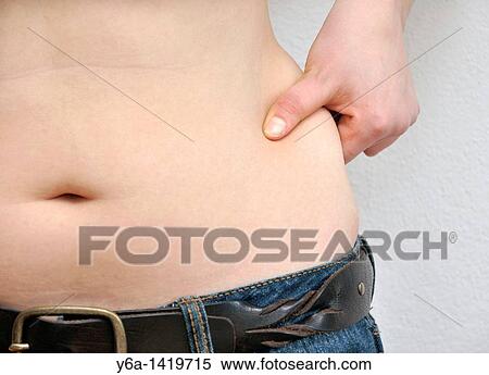 Young woman pinching love handles View Large Photo Image Stock Photography - Young woman pinching love handles. Fotosearch