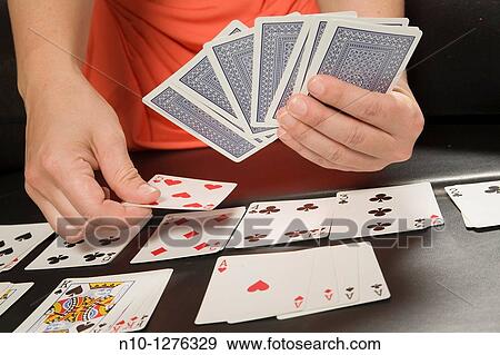 Stock Photo - Young woman playing cards. Fotosearch