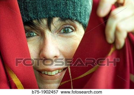 young woman playing hide and seek with happy face View Large Photo Image Stock Photo - young woman playing hide and seek with happy face. Fotosearch