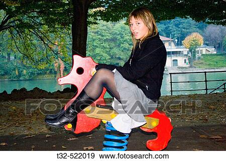 Young woman playing in park View Large Photo Image Stock Photo - Young woman playing in park. Fotosearch