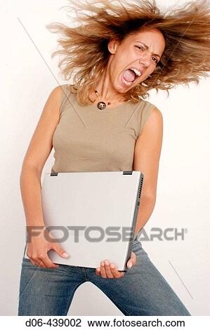 young woman playing laptop like a rock guitar View Large Photo Image Stock Image - young woman playing laptop like a rock guitar. Fotosearch