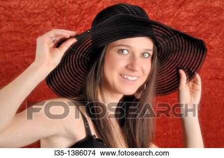 Young woman playing with old, transparent, hat View Large Photo Image Picture - Young woman playing with old, transparent, hat. Fotosearch
