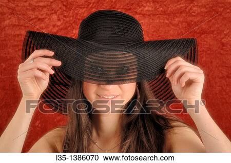 Young woman playing with old, transparent, hat View Large Photo Image Stock Image - Young woman playing with old, transparent, hat. Fotosearch