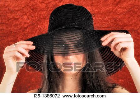 Young woman playing with old, transparent, hat View Large Photo Image Stock Image - Young woman playing with old, transparent, hat. Fotosearch