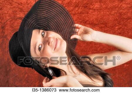 Young woman playing with old, transparent, hat View Large Photo Image Stock Image - Young woman playing with old, transparent, hat. Fotosearch