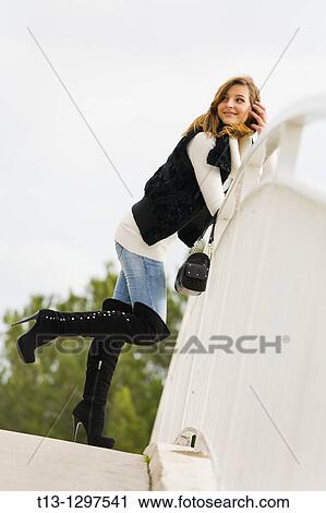 Young woman pleasantly surprised standing by the metal fence View Large Photo Image Stock Image - Young woman pleasantly surprised standing by the metal fence. Fotosearch