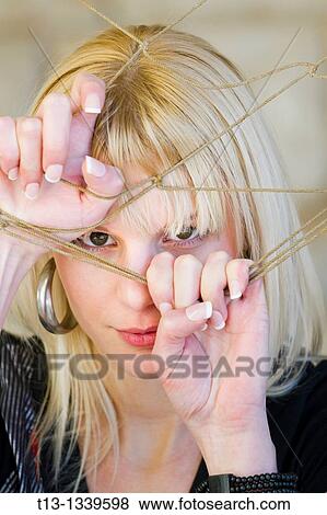 Young woman portrait caught in the net View Large Photo Image Stock Photo - Young woman portrait caught in the net. Fotosearch