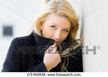 Young woman portrait in Black coat, it's cold and windy View Large Photo Image Stock Photo - Young woman portrait in Black coat, it's cold and windy. Fotosearch