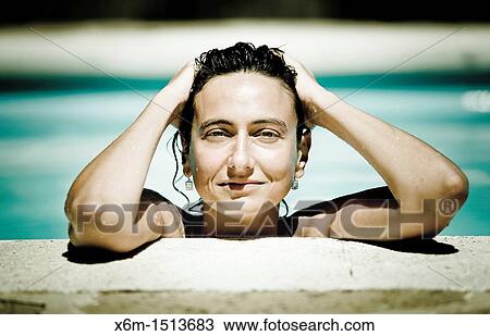 Young woman portrait on a swimming pool View Large Photo Image Stock Image - Young woman portrait on a swimming pool. Fotosearch