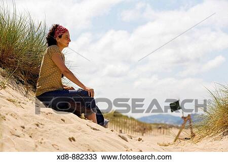 Young woman portrait sitting on a beach. Somo beach, Santander bay, Cantabria, Spain View Large Photo Image Stock Image - Young woman portrait sitting on a beach. Somo beach, Santander bay, Cantabria, Spain. Fotosearch