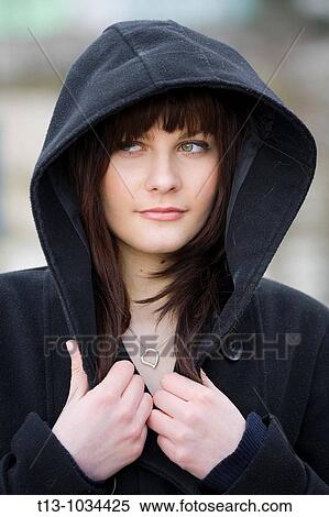 Stock Photography - Young woman portrait under the hood. Fotosearch
