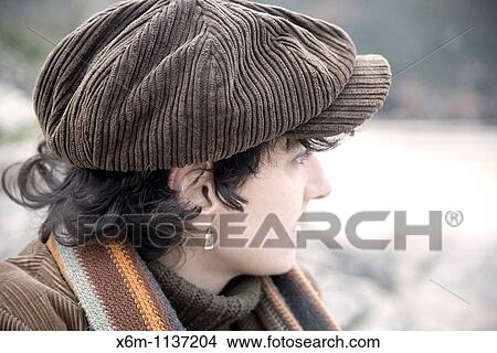 Picture - young woman portrait with a cap. Fotosearch