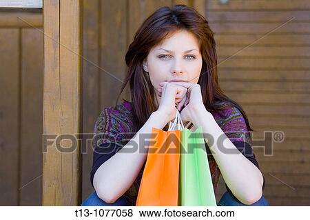 Young woman portrait with paper shopping bags View Large Photo Image Stock Photo - Young woman portrait with paper shopping bags. Fotosearch
