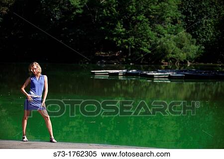 Stock Photography - Young woman poses in Central Park, New York, USA. Fotosearch