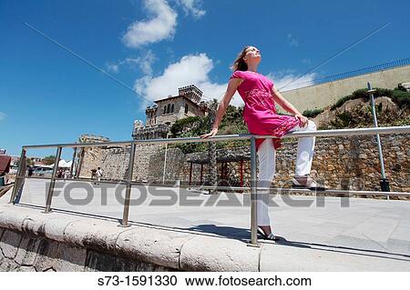 Stock Image - Young woman poses in Estoril, Forte da Cruz, Tamariz beach, Lisbon coast, Portugal, Europe. Fotosearch