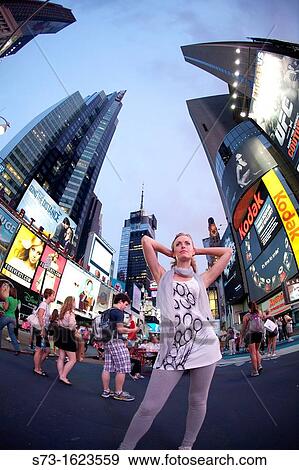 Young woman poses in Time Square, New York, USA View Large Photo Image Stock Photo - Young woman poses in Time Square, New York, USA. Fotosearch