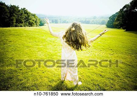 Young woman posing at a park View Large Photo Image Stock Image - Young woman posing at a park. Fotosearch