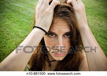 Young woman posing at a park. View Large Photo Image Stock Image - Young woman posing at a park.. Fotosearch