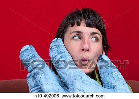 Young woman posing between the thumb and forefinger of a large sculpture of a hand View Large Photo Image Stock Photograph - Young woman posing between the thumb and forefinger of a large sculpture of a hand. Fotosearch