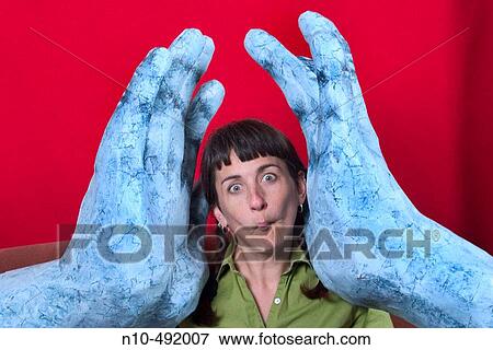 Young woman posing between two large sculptures of hands View Large Photo Image Stock Photo - Young woman posing between two large sculptures of hands. Fotosearch