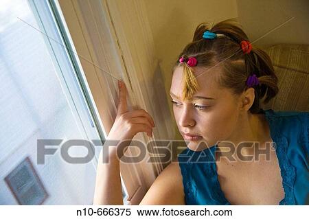 Young woman posing by a window. View Large Photo Image Stock Photography - Young woman posing by a window.. Fotosearch