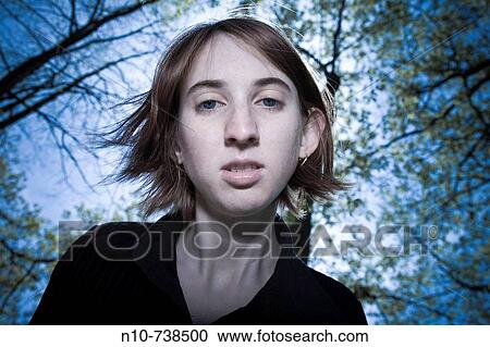 Young woman posing in a park. View Large Photo Image Stock Image - Young woman posing in a park.. Fotosearch