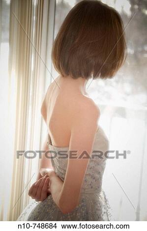 Picture - Young woman posing in a prom dress.. Fotosearch