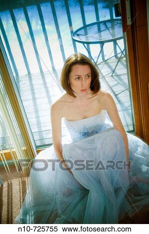 Stock Photography - Young woman posing in a prom dress.. Fotosearch
