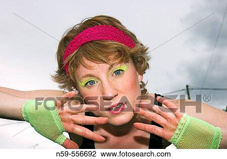 Stock Image - Young woman posing in eigthies dance / fitness fashion.. Fotosearch