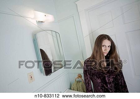 Young woman posing in her bathroom. View Large Photo Image Stock Image - Young woman posing in her bathroom.. Fotosearch