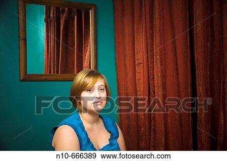 Young woman posing in her bedroom. View Large Photo Image Stock Photo - Young woman posing in her bedroom.. Fotosearch