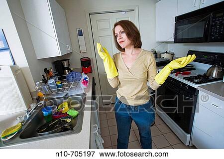 Young woman posing in her kitchen View Large Photo Image Stock Photo - Young woman posing in her kitchen. Fotosearch