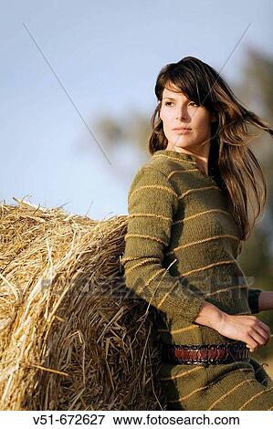Young woman posing in the countryside View Large Photo Image Stock Photo - Young woman posing in the countryside. Fotosearch