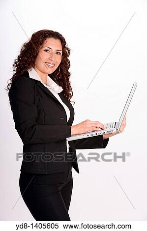 Young woman posing in the studio as an executive with laptop View Large Photo Image Stock Photography - Young woman posing in the studio as an executive with laptop. Fotosearch