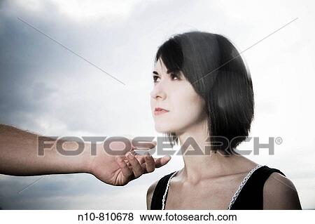 Young woman posing next to a young man's hand and arm View Large Photo Image Stock Photo - Young woman posing next to a young man's hand and arm. Fotosearch