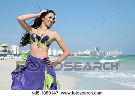 Stock Photo - Young woman posing on the beach, Miami Beach, Florida, USA. Fotosearch