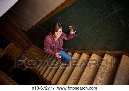 Young woman posing on the stairwell of her apartment building. View Large Photo Image Stock Photo - Young woman posing on the stairwell of her apartment building.. Fotosearch