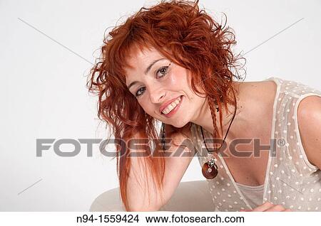 Young woman posing redhead during a study session View Large Photo Image Picture - Young woman posing redhead during a study session. Fotosearch