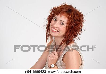 Young woman posing redhead during a study session View Large Photo Image Stock Image - Young woman posing redhead during a study session. Fotosearch
