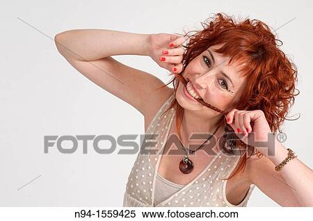 Young woman posing redhead during a study session View Large Photo Image Stock Photography - Young woman posing redhead during a study session. Fotosearch