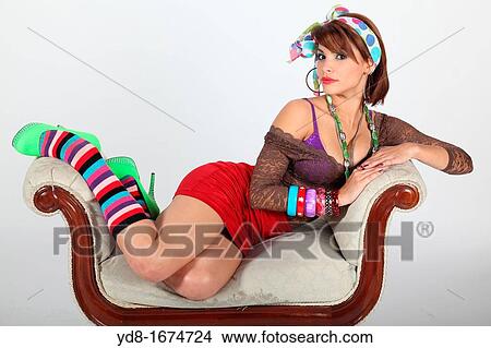 Young woman posing sitting in the Studio View Large Photo Image Picture - Young woman posing sitting in the Studio. Fotosearch