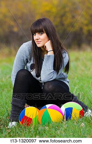 Young woman posing with colorful balls spread View Large Photo Image Stock Photo - Young woman posing with colorful balls spread. Fotosearch