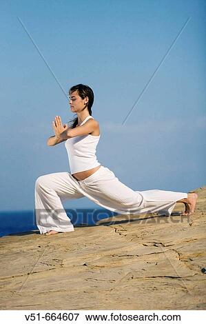 Young woman practicing yoga by the sea. View Large Photo Image Stock Photo - Young woman practicing yoga by the sea.. Fotosearch