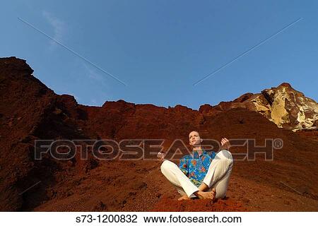 Young woman practicing yoga in the Red Beach in Santorini, Cyclades Islands, Greece View Large Photo Image Stock Image - Young woman practicing yoga in the Red Beach in Santorini, Cyclades Islands, Greece. Fotosearch