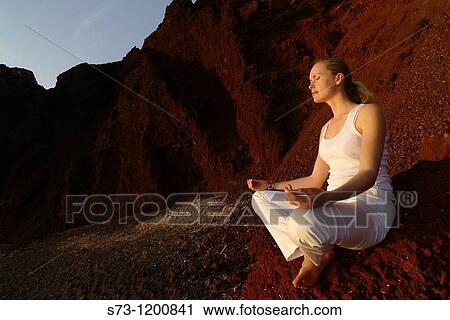 Young woman practicing yoga in the Red Beach in Santorini, Cyclades Islands, Greece View Large Photo Image Stock Image - Young woman practicing yoga in the Red Beach in Santorini, Cyclades Islands, Greece. Fotosearch