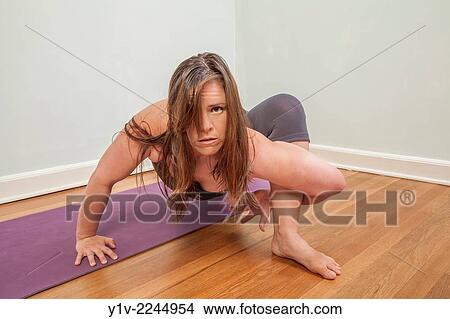 Picture - Young woman practicing yoga.. Fotosearch