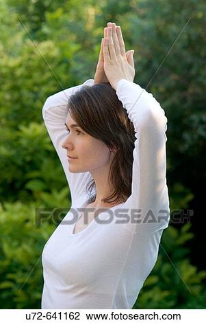 Stock Image - Young Woman Practicing Yoga. Fotosearch
