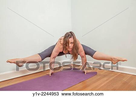 Stock Image - Young woman practicing yoga.. Fotosearch