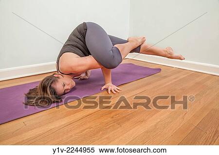 Stock Photography - Young woman practicing yoga.. Fotosearch