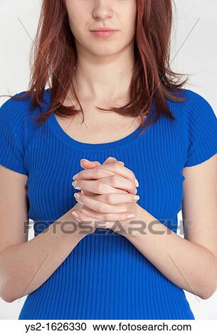 Young woman praying View Large Photo Image Stock Image - Young woman praying. Fotosearch